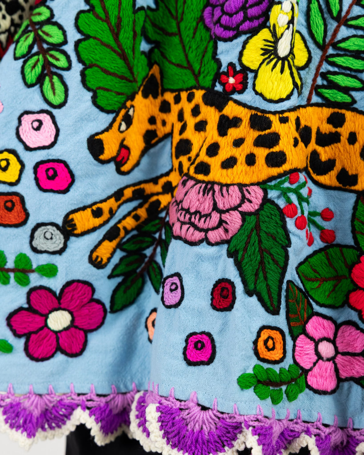 Blue short sleeve cotton top with hand stitched animal print